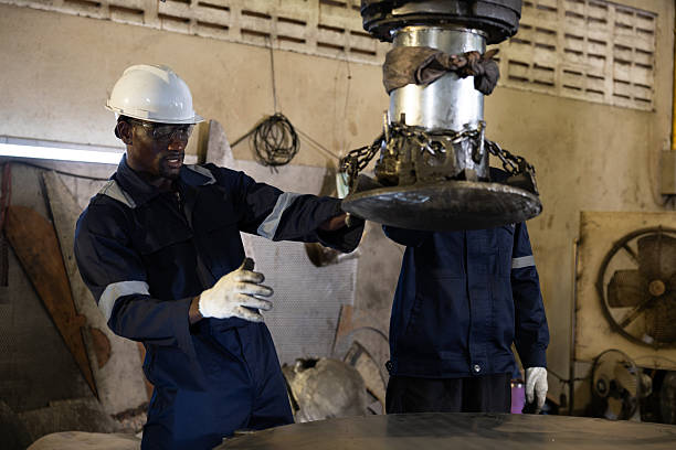 African factory worker controlling large machine with focus 35240