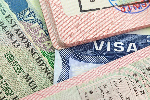 Chinese, USA and Shengen European visas in passports - adventure background NEW opportunities press